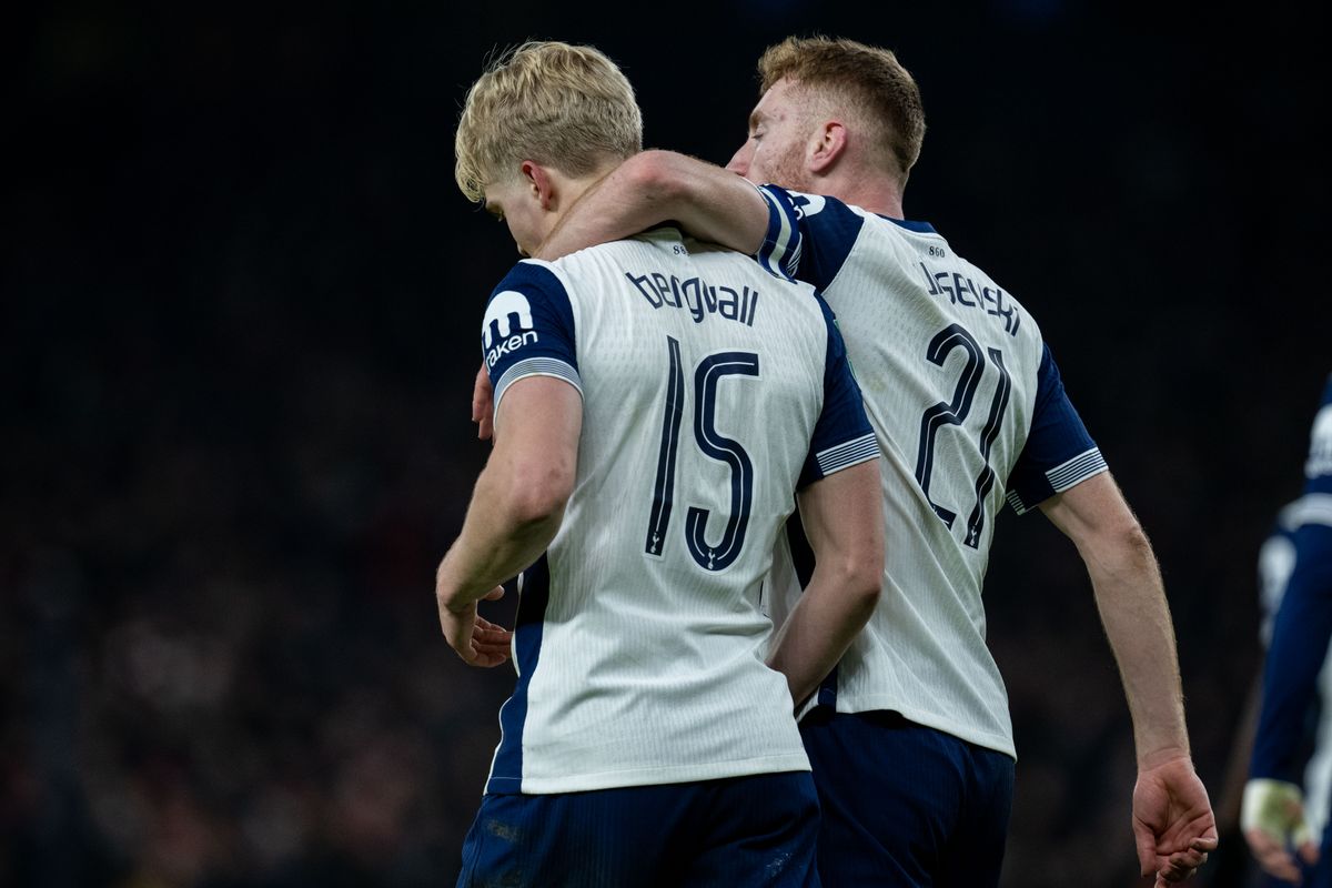 Pictured from behind, Lucas Bergvall is embraced by a Tottenham Hotspur teammate