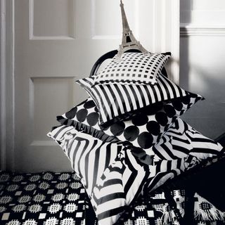 geometric cushions on bed.