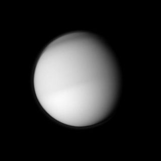 Titan's northern half, where it's early spring, appears slightly darker than the southern half, where it's early fall, in this image taken on March 22, 2010. Like Earth, Titan has four distinct seasons, each of which lasts about seven of Earth's years.