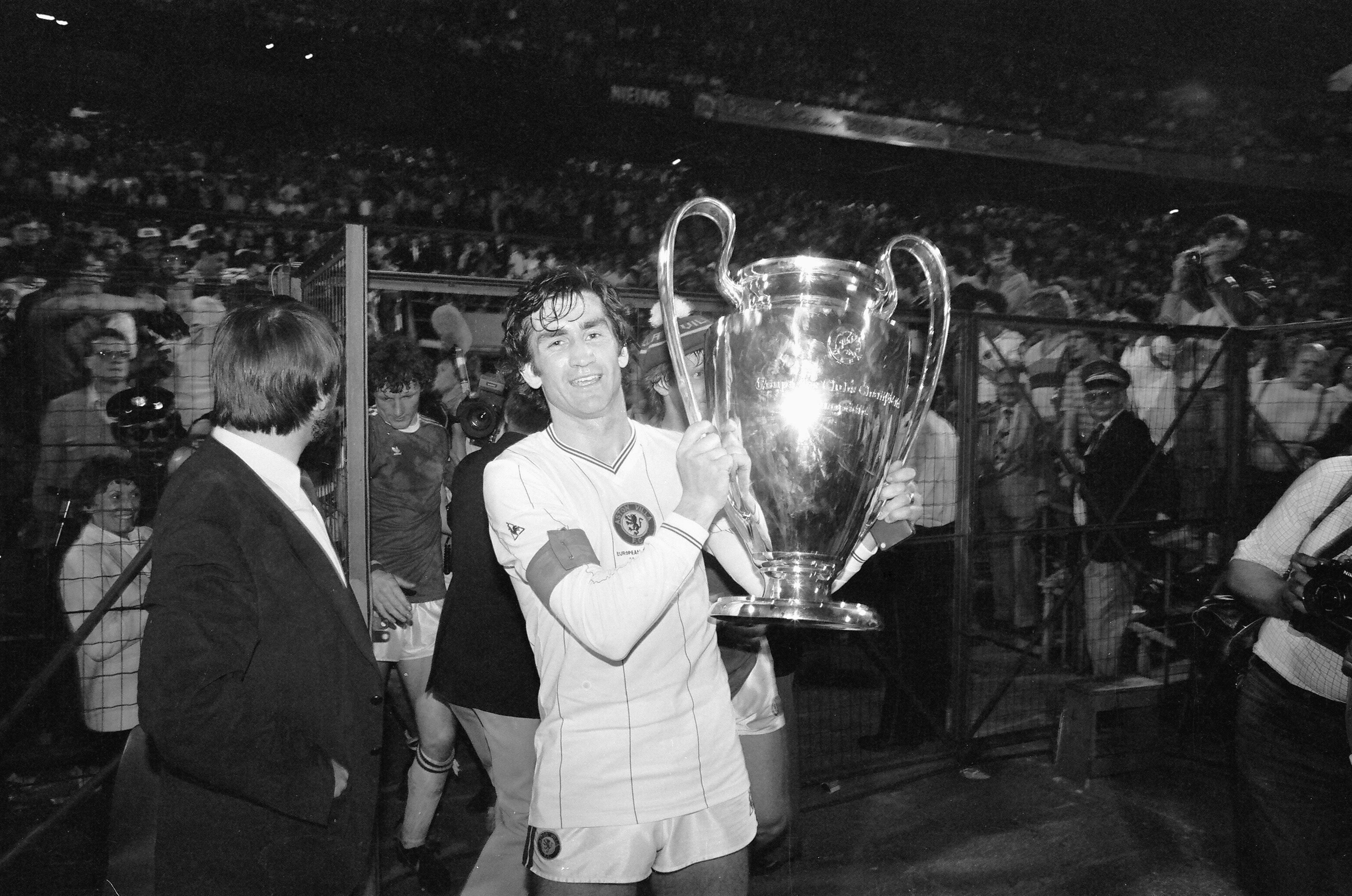 Aston Villa captain Dennis Mortimer celebrates with the European Cup after his side's victory over Bayern Munich in the 1981/82 final in Rotterdam