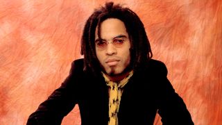 Lenny Kravitz posing for a photograph in round sunglasses in 1990