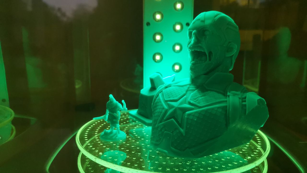 Two prints from the formlabs form 3 being cured under UV light