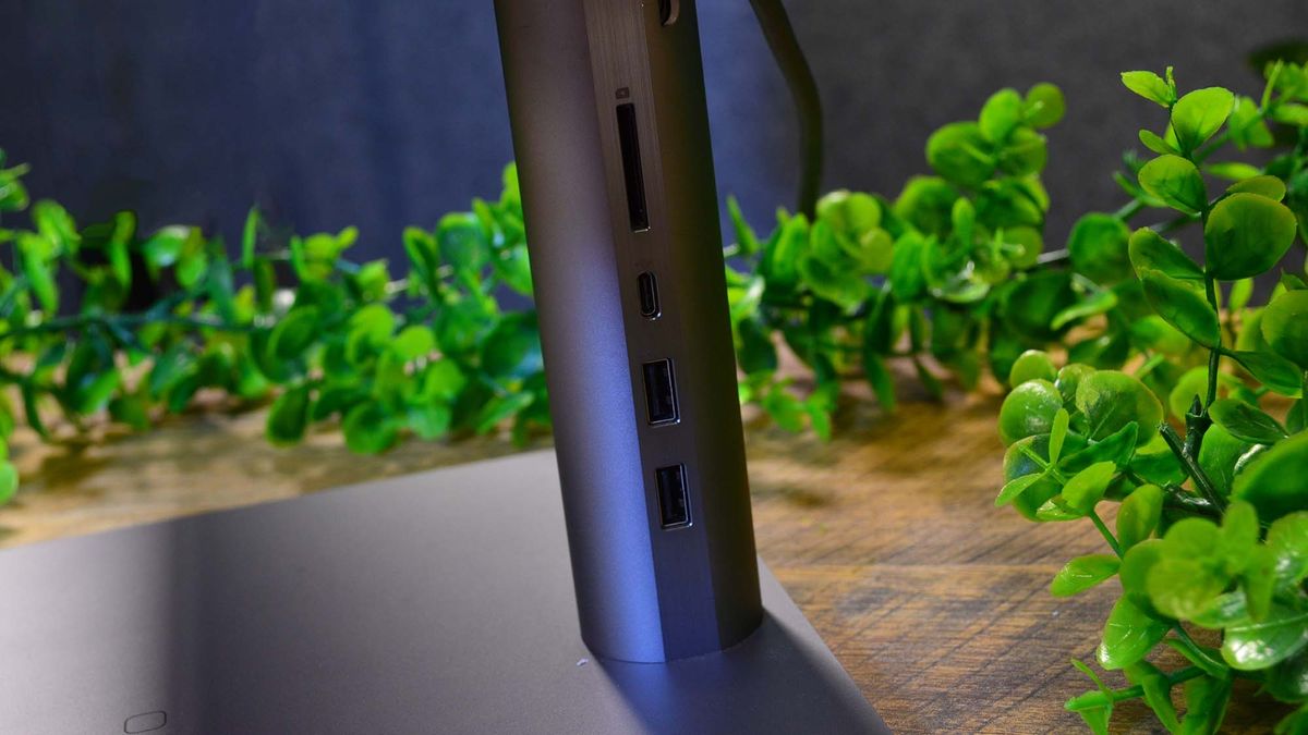 An HP Envy 34 on a desk in front of a plant