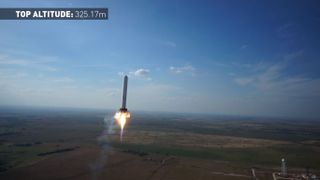 SpaceX's reusable Grasshopper reaches a new record height of just over 1,066 feet (325 meters) on June 14, 2013 during a test flight from its McGregor, Texas proving ground. This image is a still from a video recorded by an unmanned hexacopter drone.