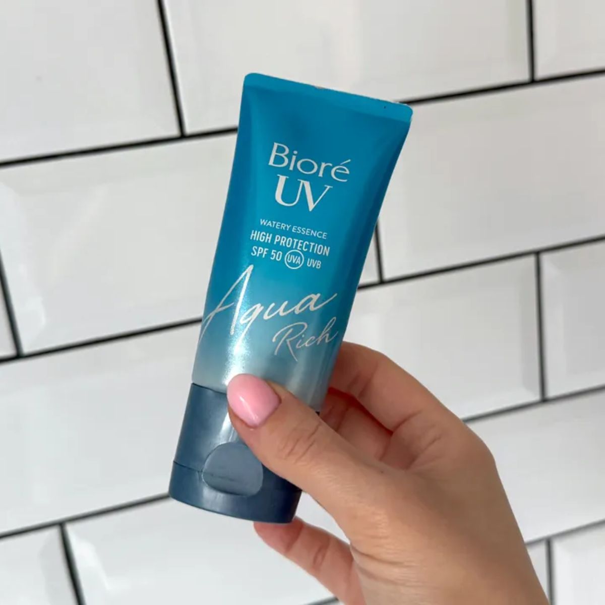 Lucy Abbersteen holding the Bioré UV Aqua Rich Watery Essence SPF 50 