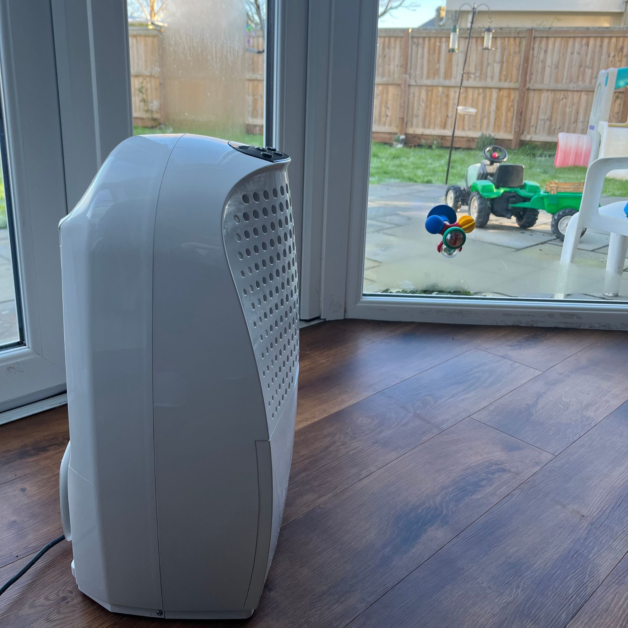 Ebac 4850 21 Litre Dehumidifier next to window with condensation