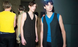 Male models wearing Raf Simons clothing