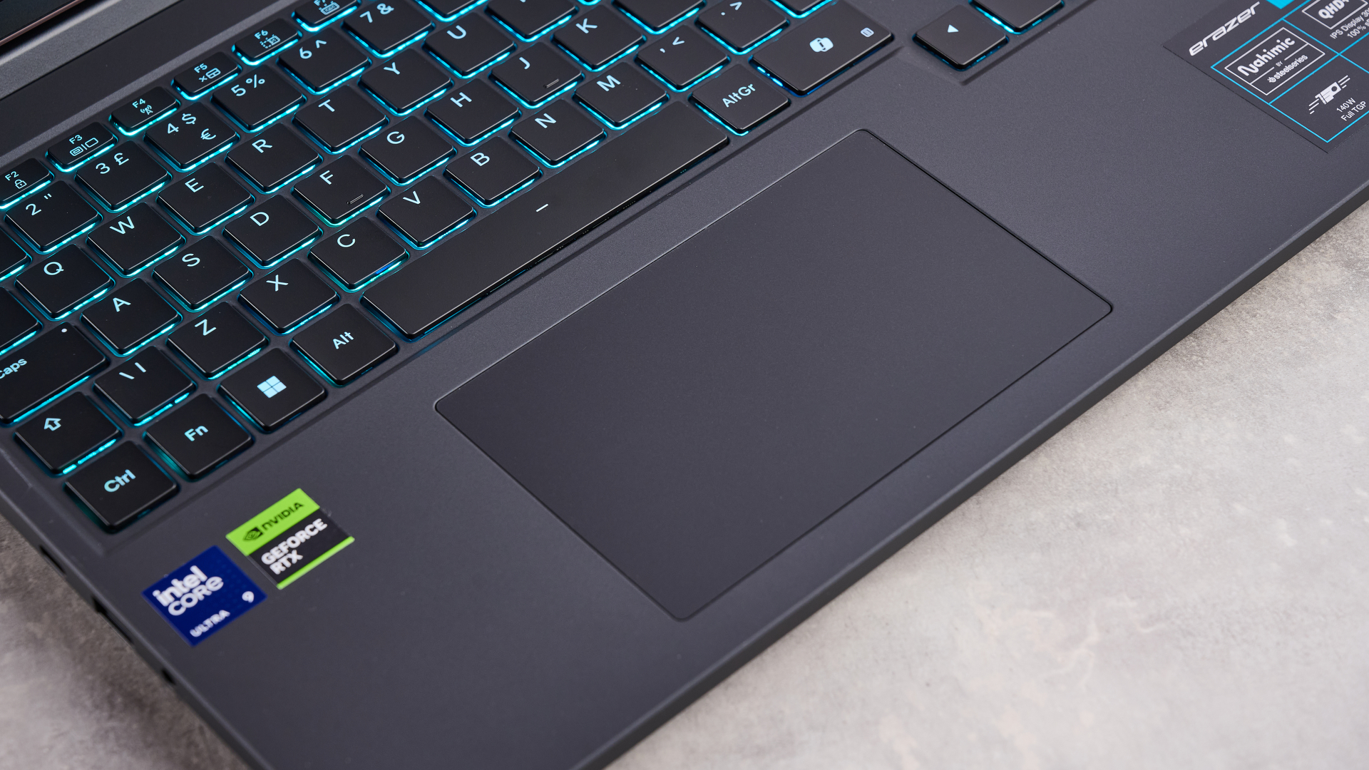 Close-up of touchpad on Medion Erazer Major 16 X1, on a white desk