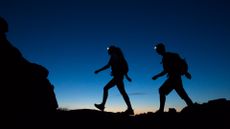 A couple hiking at night