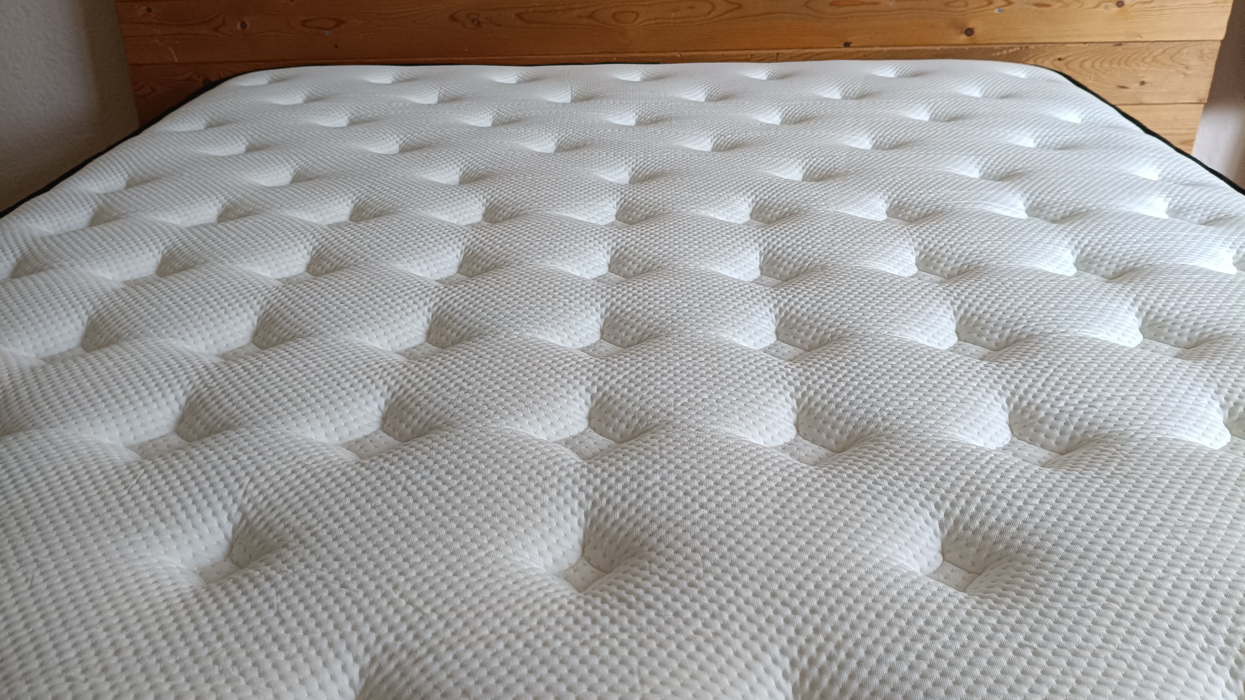 Looking across the length of the mattress, the image captures the uniform texture and expansive sleeping surface of the LumbarCloud model.
