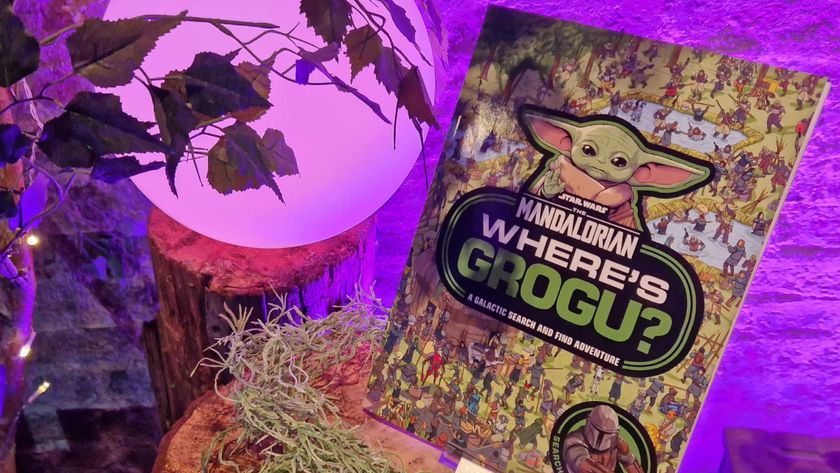 A 'Where's Grogu?' book on a wooden log, surrounded by leaves and moss, with a purple orb visible in the background
