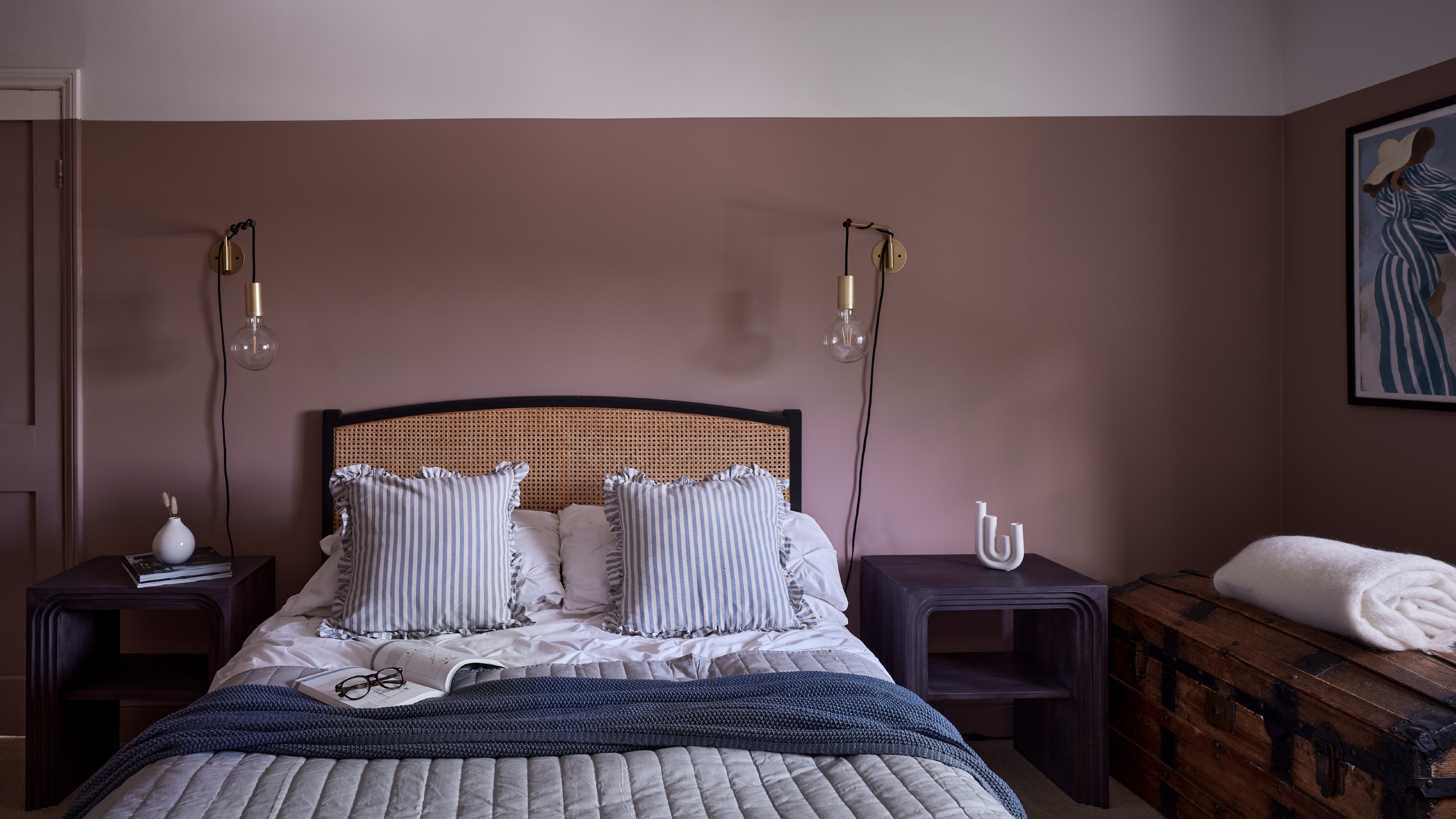 A bedroom painted in Farrow &amp; Ball's Sulking Room Pink with the top of the walls and the ceiling painted white