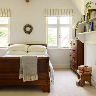 white bedroom with wooden bed and carpet floor