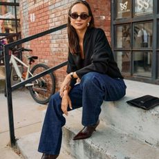 Woman in black sweater and jeans