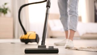 A woman vacuuming a floor