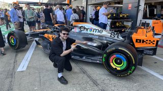 Article author Mo Harber-Lamond next to Oscar Piastri’s McLaren F1 car