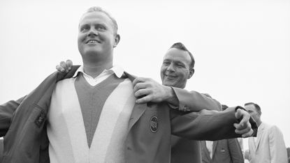 Jack Nicklaus being helped into the Green Jacket by Arnold Palmer after winning the 1965 Masters