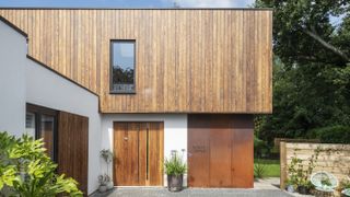 contemporary house with corten steel cladding and vertical timber cladding
