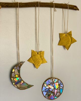 Christmas hanging decorations with stars and moons with mosaics made from CDs