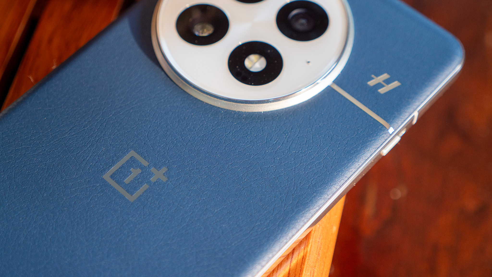 A close-up of the textured vegan leather on the back of the Ocean blue OnePlus 13