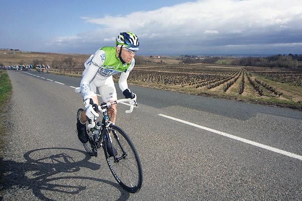 A rider attacks the bunch in pursuit of the three leaders.