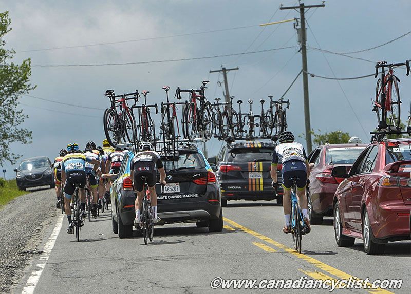 Riders at the back shelter from the wind in the team cars