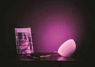 Philips Hue Go on a desk with a purple hue