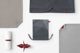 Textile items and origami figure laid out from Nendo's inflight amenity kit