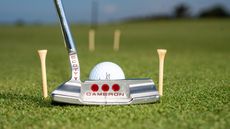 A Scotty Cameron putter lining up a ball on the 16th green at Royal Troon
