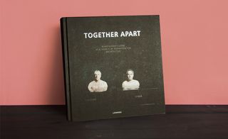 Black with white lettering and images, front cover of the book 'Together Apart', dark wood surface, orange background