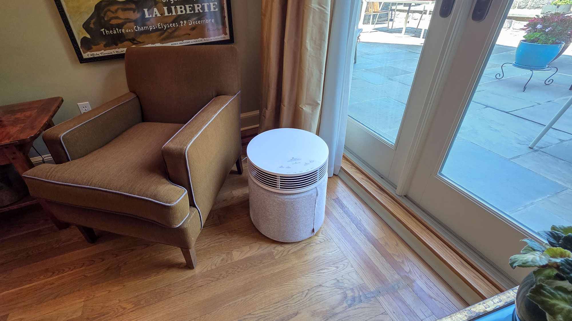 Blueair Blue Signature purifier next to brown armchair