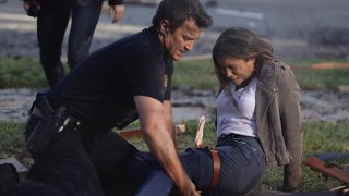 Nathan Fillion helping Jenna Dewan on The Rookie.