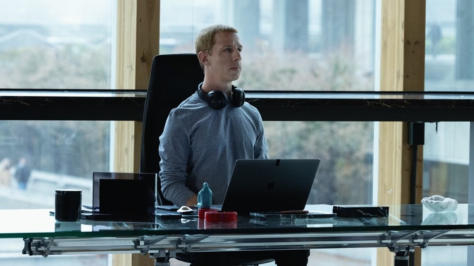 jeremy strong as mark zuckerberg sitting upright in front of a laptop at a desk in the social reckoning