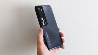 The Poco M3 Pro 5G from the back, held in someone's hand