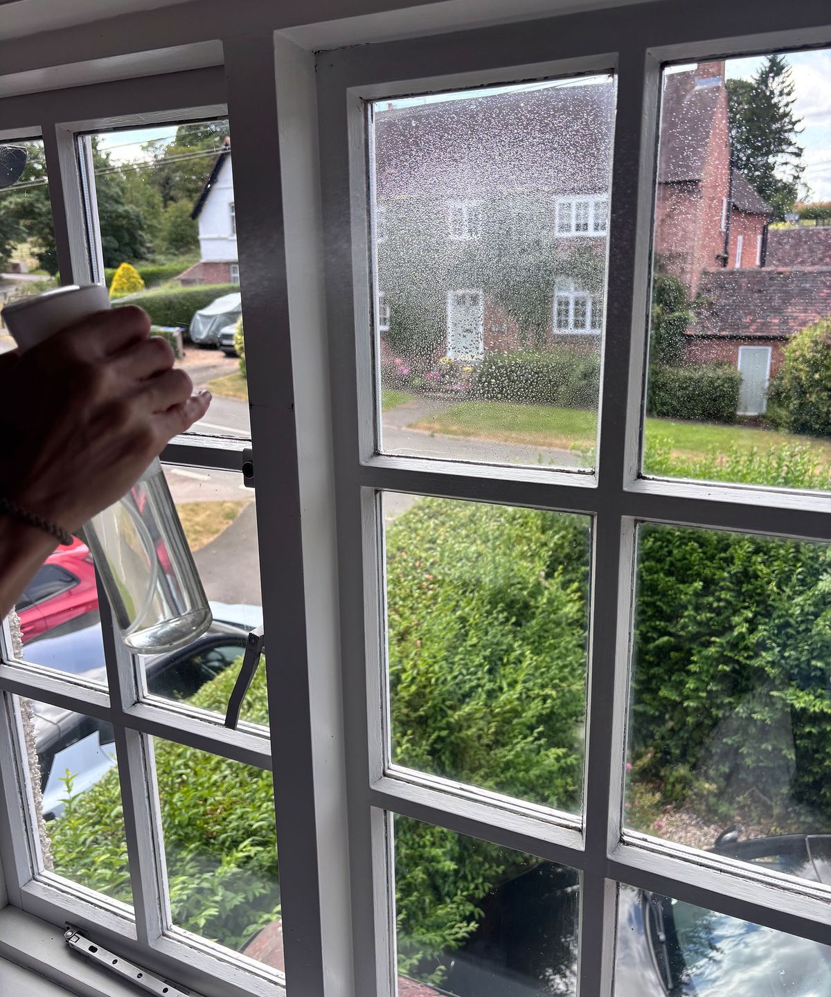 spraying a window with soapy water
