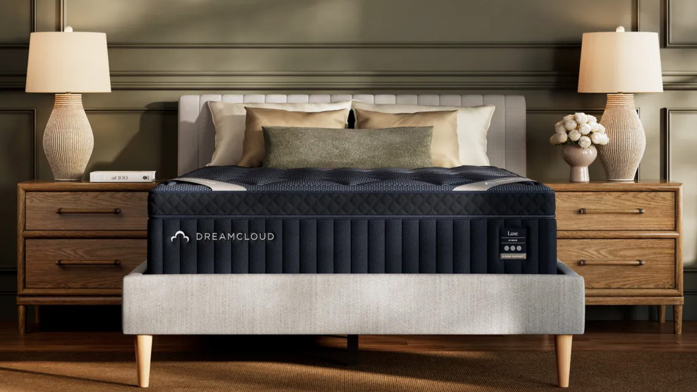 DreamCloud Luxe Hybrid Mattress new for 2025 sitting on a low profile platform bed frame with a headboard