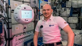 European Space Agency astronaut Alexander Gerst of German poses for a photo with the robot CIMON on board the International Space Station. The robot is designed to be a companion for astronauts in space.
