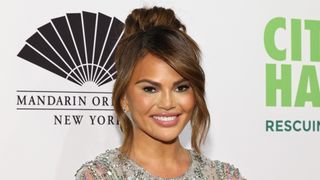 Chrissy Teigen with chestnut brown hair one of the hottest autumn hair colors