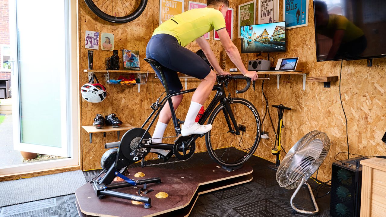 Male cyclist using an indoor cycling rocker plate