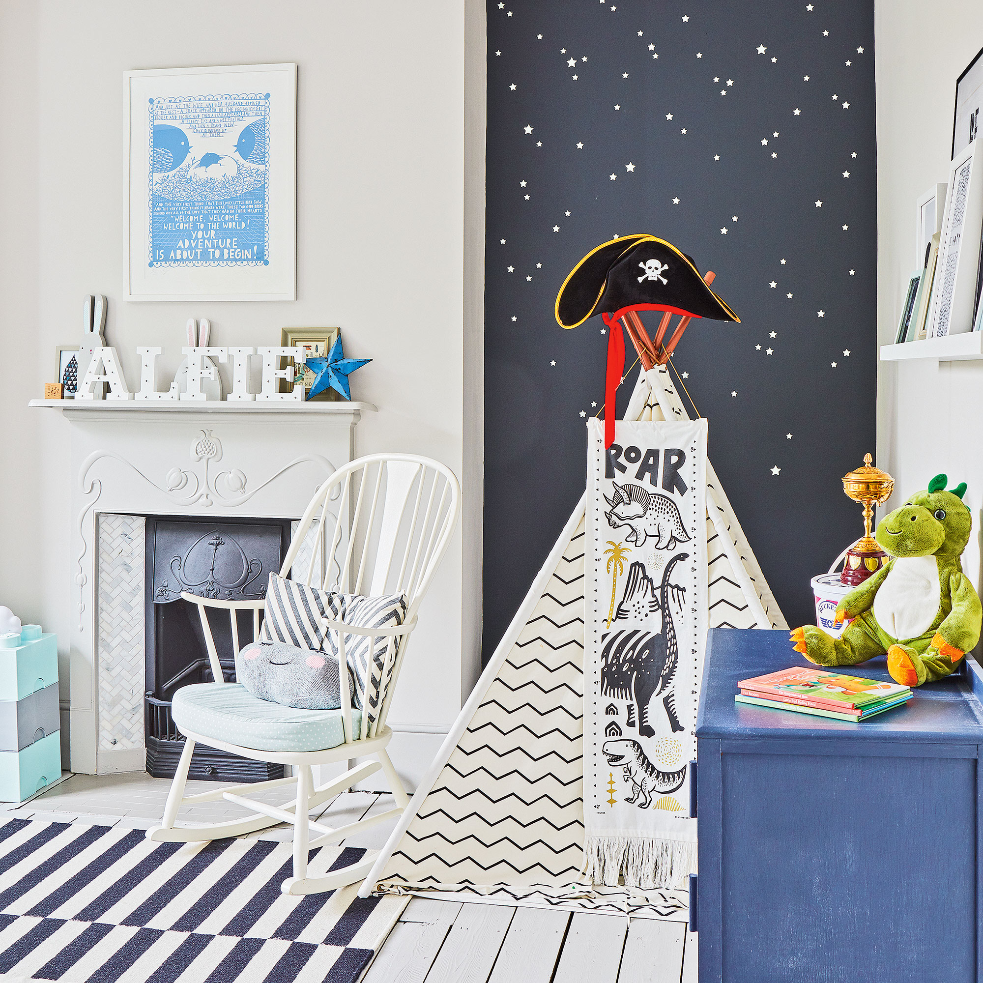 White and blue nursery with wallpapered alcove and a white play teepee