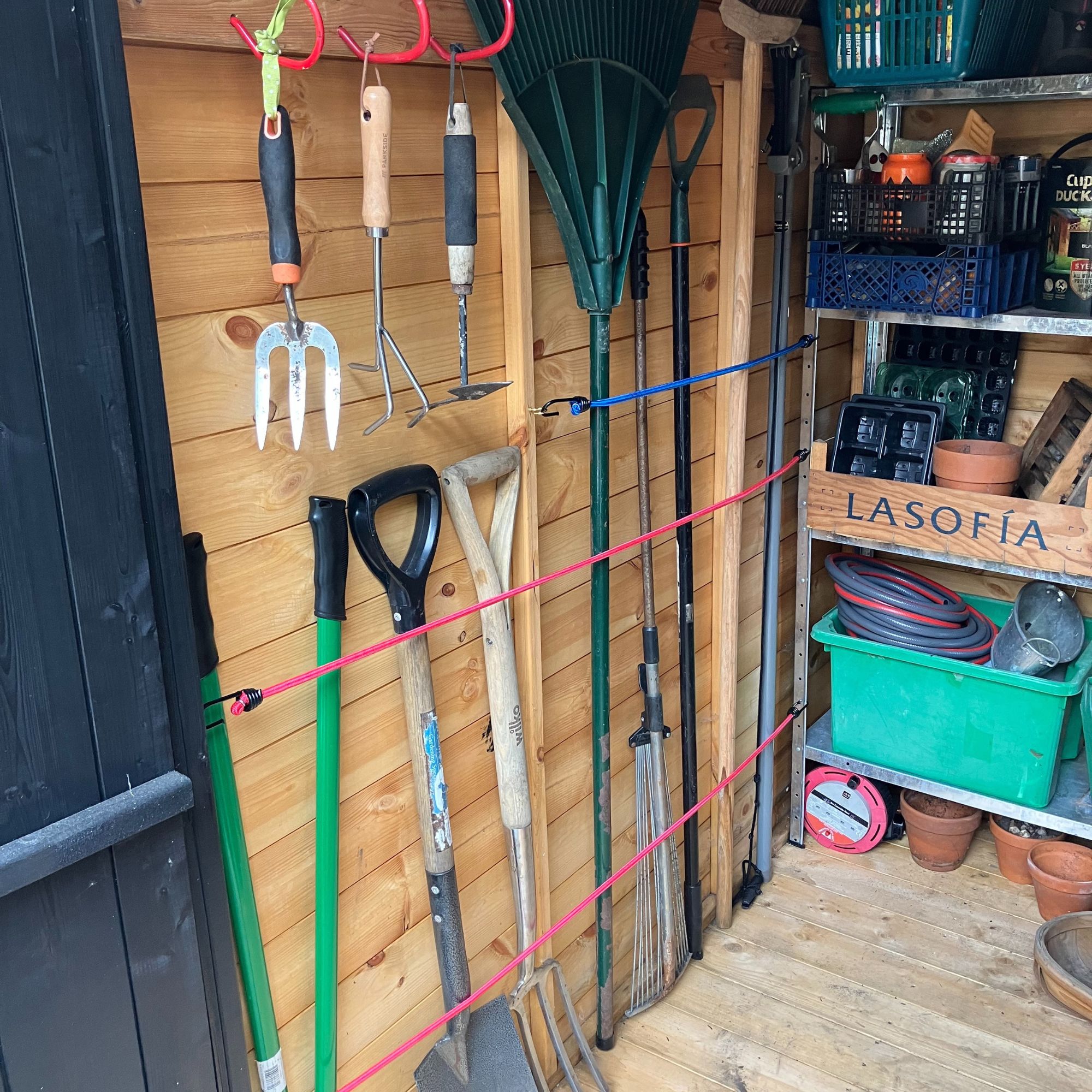 bungee cord shed storage with garden tools