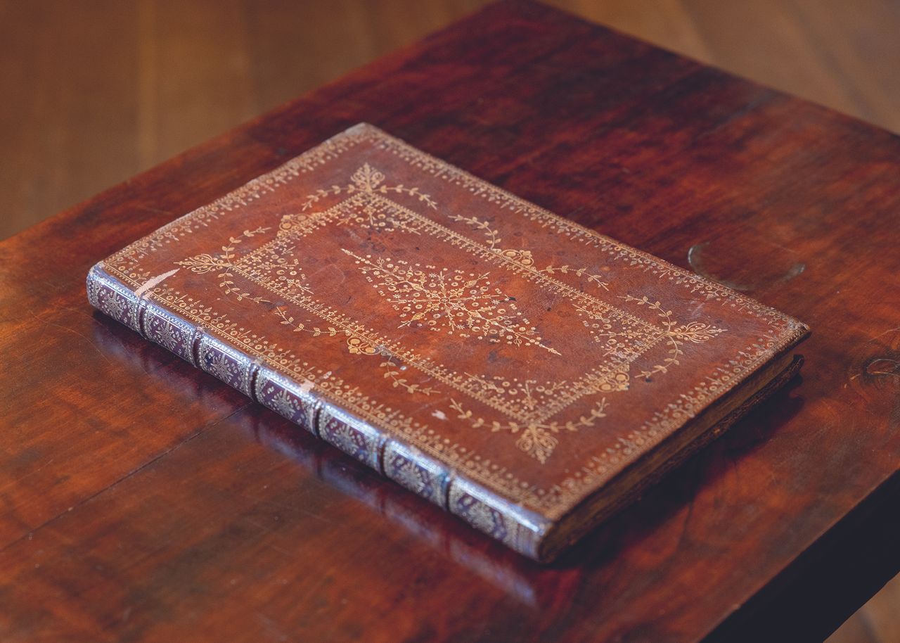 Charlie Courtenay, 19th Earl of Devon with his ancestor's book at Powderham Castle.