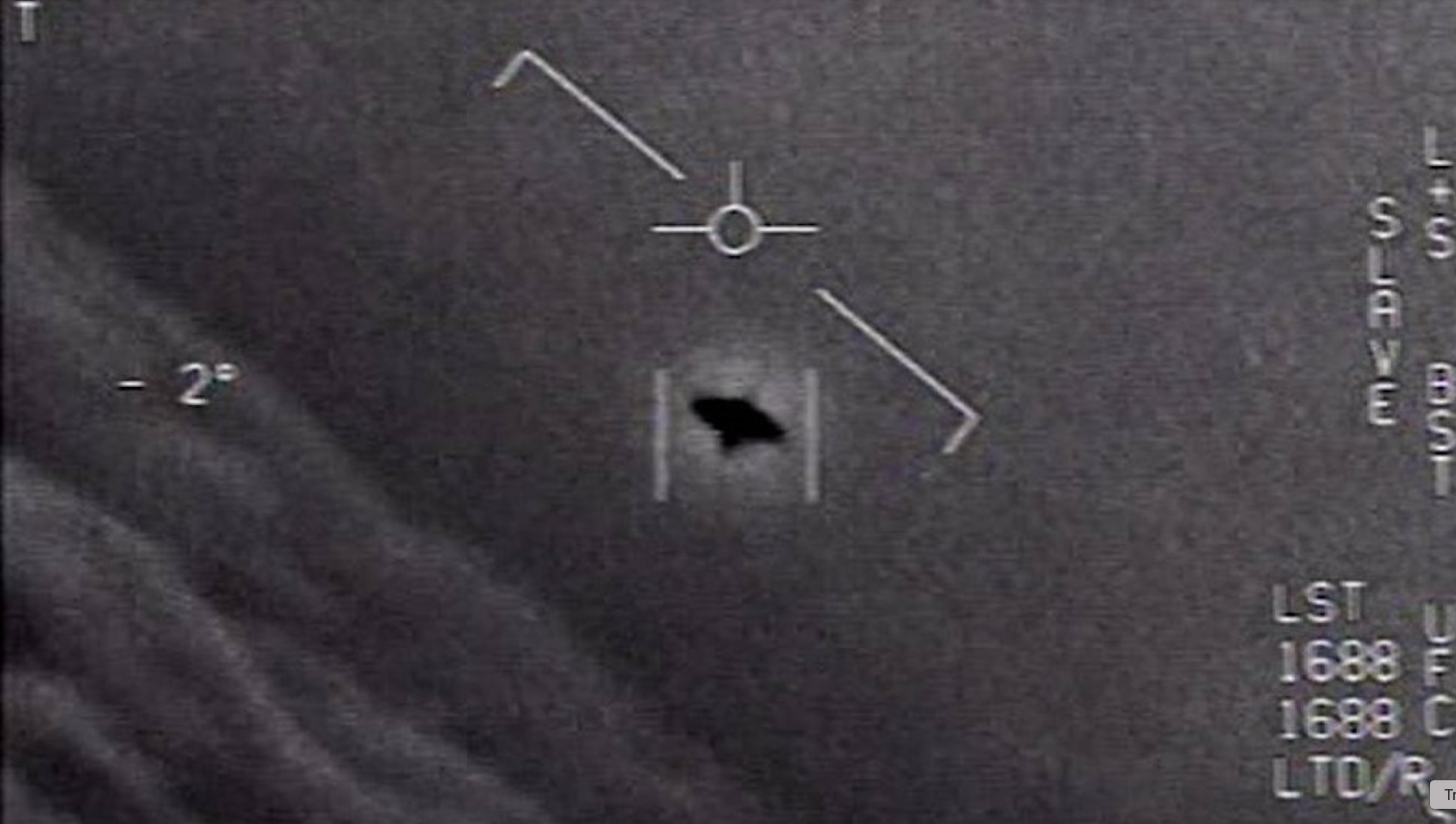 black and white photo taken by a fighter jet's camera, showing a black disk in a cloudy sky