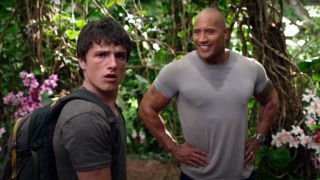 Josh Hutcherson look on in disbelief while Dwayne Johnson smiles in Journey 2: The Mysterious Island.