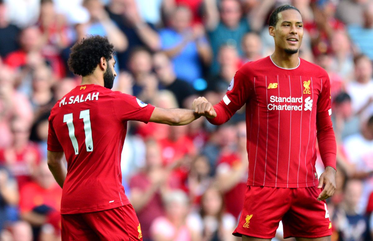 Liverpool&#039;s Mohamed Salah (left) celebrates scoring his side&#039;s second goal of the game with team-mate Virgil van Dijk during the Premier League match at Anfield, Liverpool.