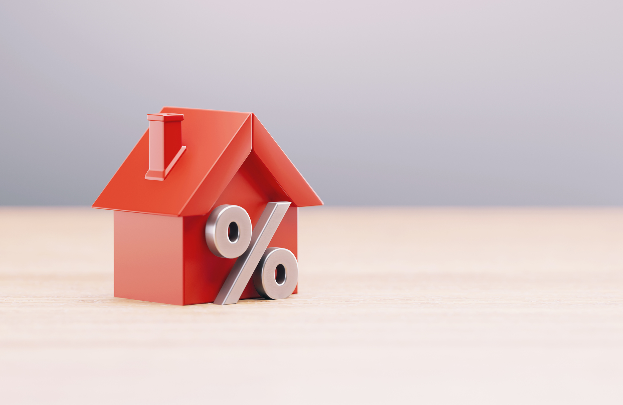 Red House Object And Percentage Sign In Front Of Grey Defocused Background 