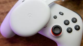 Chromecast with Google TV on top of Stadia Controller
