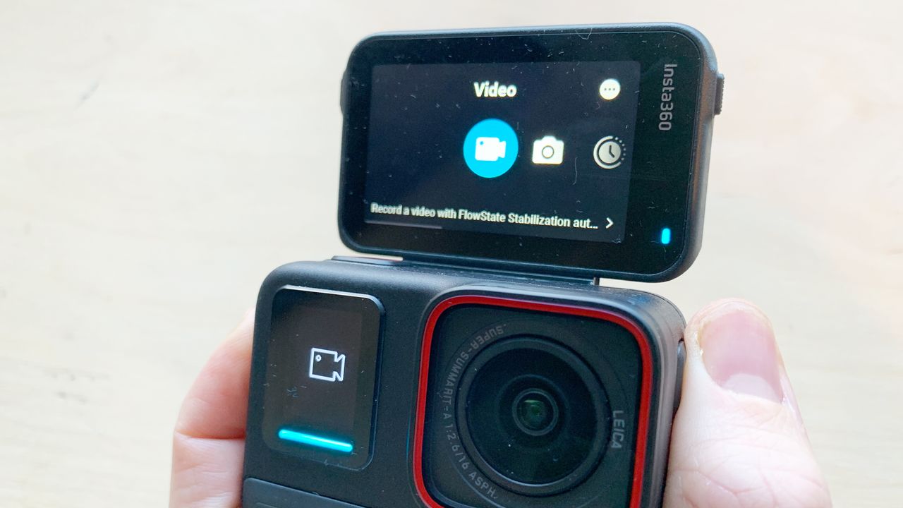 Image of the front of an Insta360 Ace Pro action camera with rear touchscreen flipped up to face the front