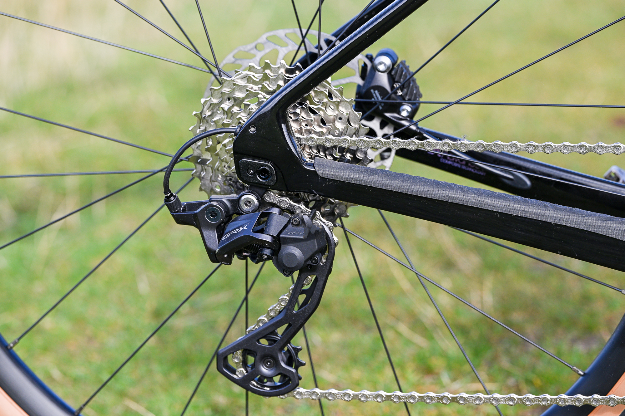 close up of the rear derailleur and cassette on a black bike