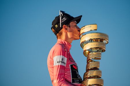Jonas Vingegaard kisses the Giro d'Italia trophy on the podium in Rome